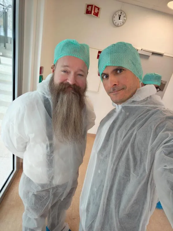 Hassan with a colleague in cleanroom gear
